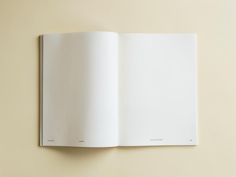 Open editorial magazine on a warm cream desk